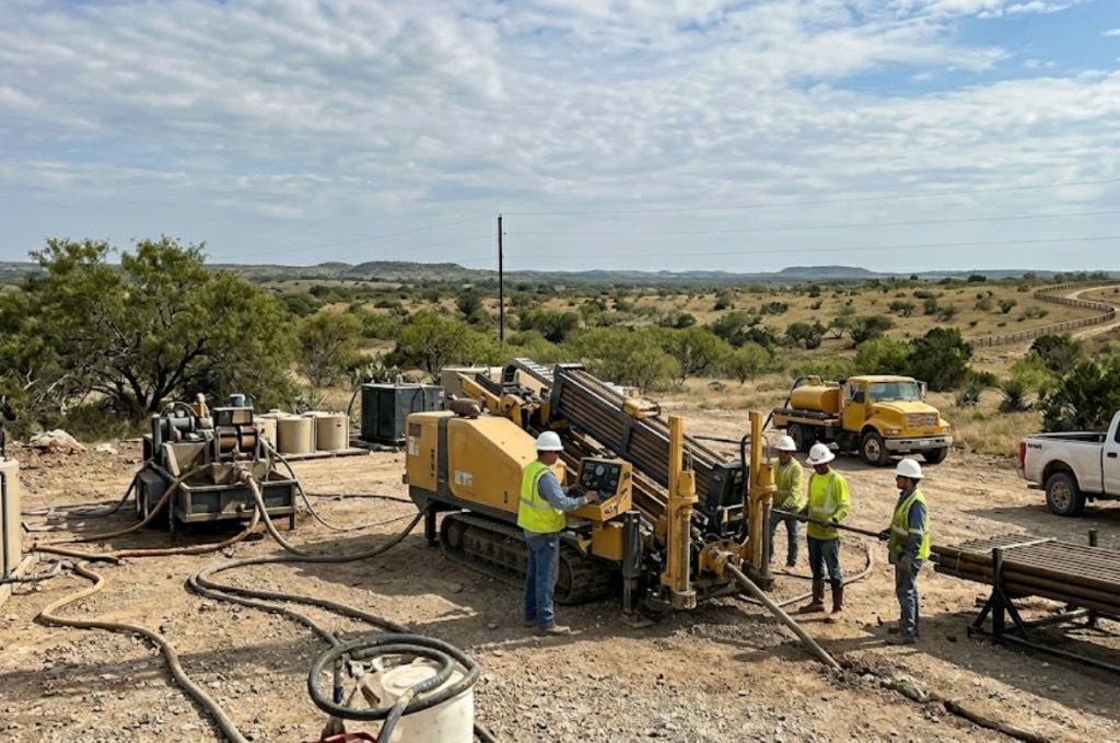 Directional drilling and directional boring in Texas — yellow HDD rig and crew performing directional drilling on a rural Texas utility job site